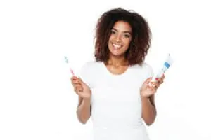 woman holding toothpaste